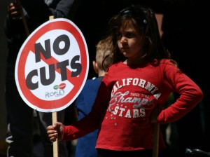 Young emboldened activist stands defiantly for "No Cuts"