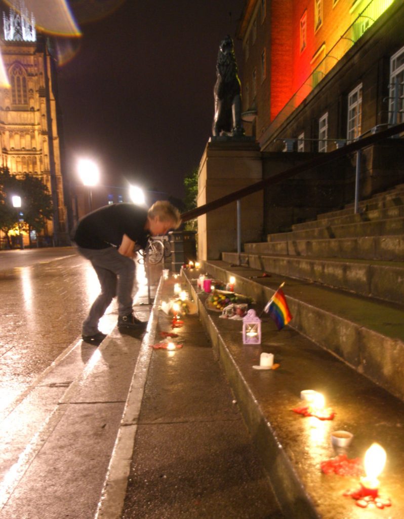 Lighting candles at Norwich City Hall, Orlando LGBT Vigil